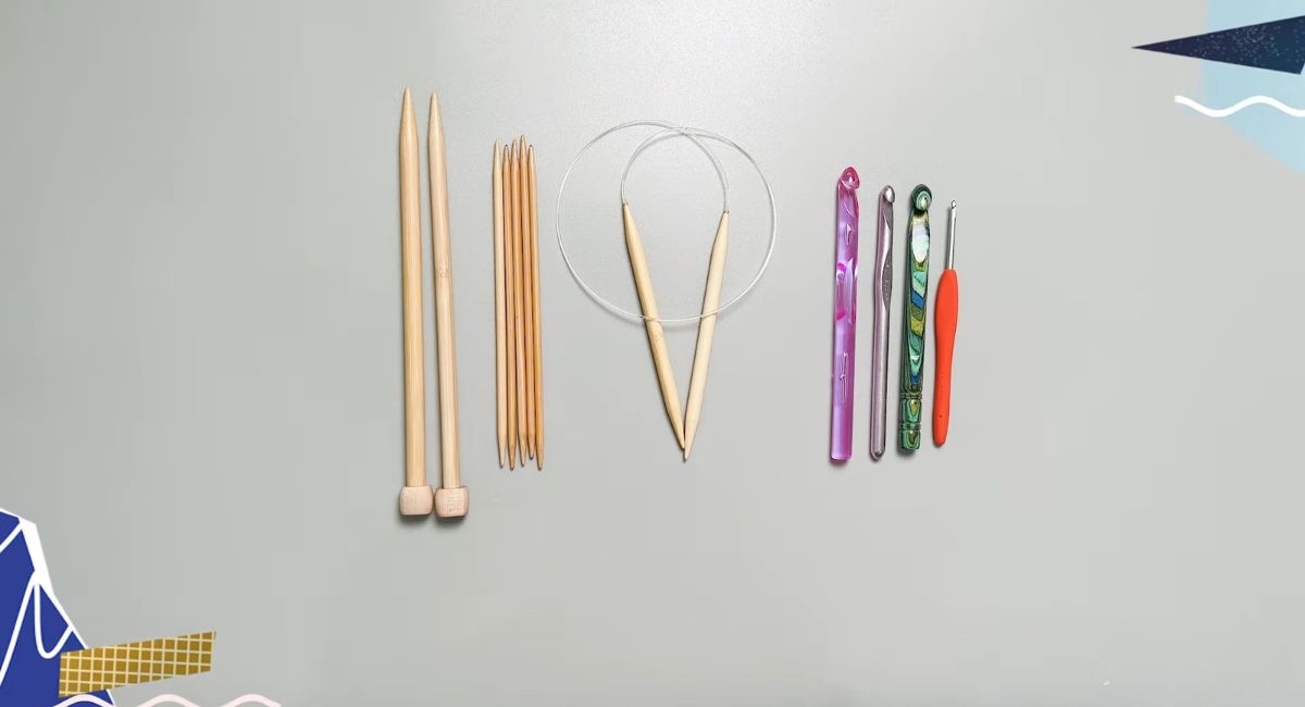 Different types of knitting needles and crochet hooks arranged side by side.